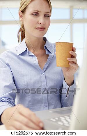 Stock Photography - Businesswoman with laptop and coffee. Fotosearch