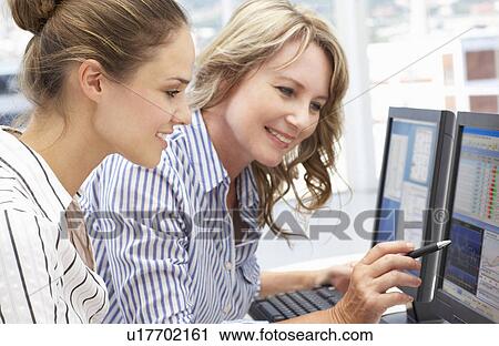 Businesswomen working on computers View Large Photo Image Stock Image - Businesswomen working on computers. Fotosearch