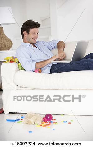 Busy father working on laptop View Large Photo Image Picture - Busy father working on laptop. Fotosearch