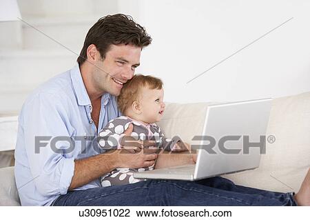 Busy father working on laptop View Large Photo Image Stock Image - Busy father working on laptop. Fotosearch