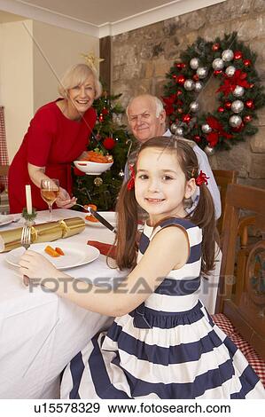 Child having Christmas dinner with grandparents View Large Photo Image Stock Photo - Child having Christmas dinner with grandparents. Fotosearch