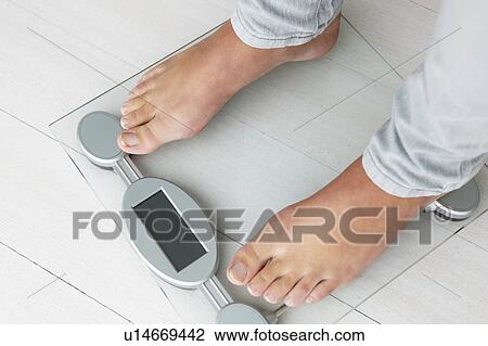 Close up detail girl weighing herself View Large Photo Image Stock Image - Close up detail girl weighing herself. Fotosearch