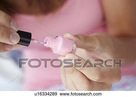 Stock Photo - Close up detail teenage girl painting nails. Fotosearch