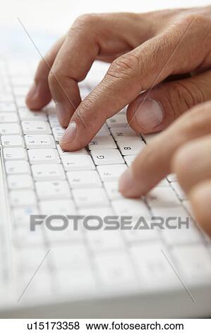 Stock Photo - Close up man using computer keyboard. Fotosearch