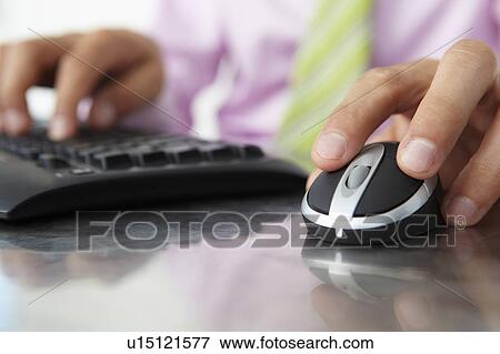 Stock Photo - Close up man using keyboard and mouse. Fotosearch