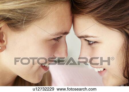 Stock Photo - Close up portrait of teenage girls in profile. Fotosearch