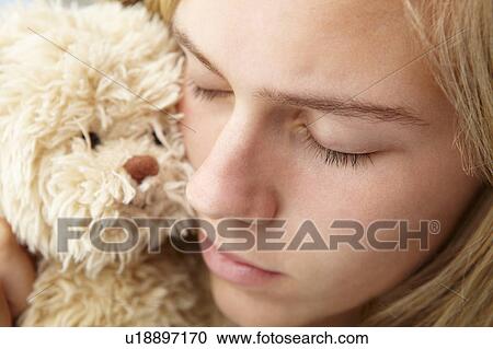 Stock Image - Close up teenage girl with cuddly toy. Fotosearch