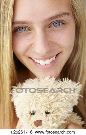 Stock Photograph - Close up teenage girl with cuddly toy. Fotosearch
