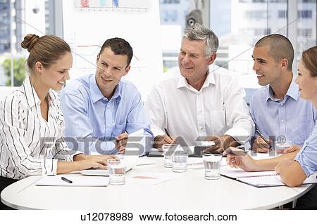 Stock Photo - Colleagues in business meeting. Fotosearch