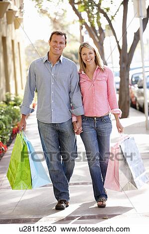 Couple carrying shopping View Large Photo Image Stock Image - Couple carrying shopping. Fotosearch