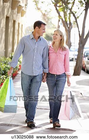 Stock Photo - Couple carrying shopping. Fotosearch