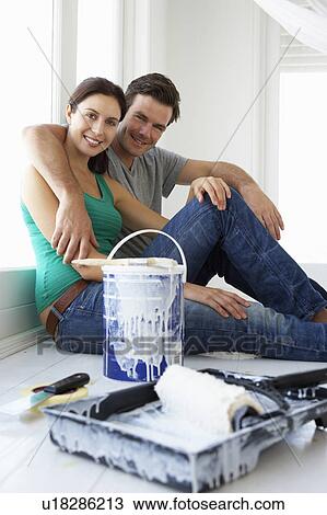 Stock Image - Couple decorating house. Fotosearch