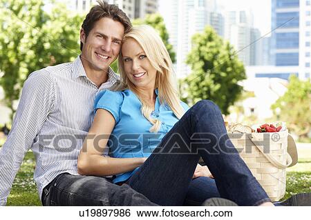 Stock Photograph - Couple in city park with picnic. Fotosearch
