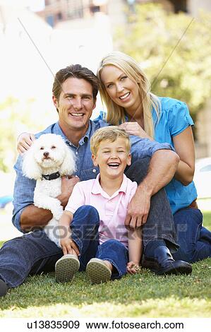 Stock Photo - Couple in city park with young son and dog. Fotosearch