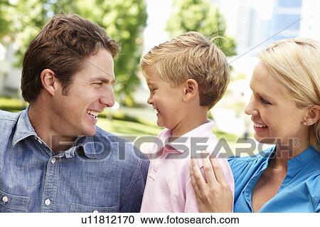 Couple in city park with young son View Large Photo Image Stock Image - Couple in city park with young son. Fotosearch