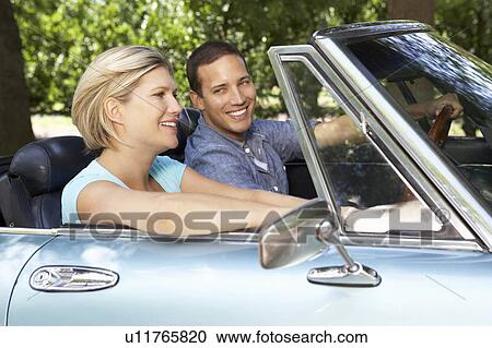 Couple in sports car View Large Photo Image Stock Image - Couple in sports car. Fotosearch