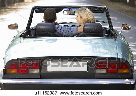 Stock Photo - Couple in sports car. Fotosearch