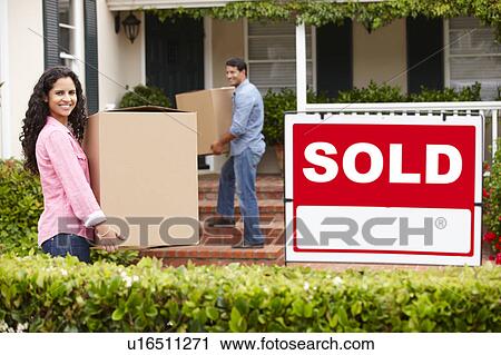 Stock Image - Couple moving into new home. Fotosearch