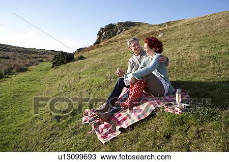Stock Image - Couple on country picnic. Fotosearch