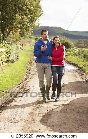 Stock Image - Couple on country walk. Fotosearch