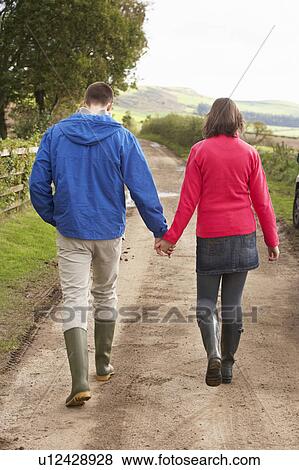Couple on country walk View Large Photo Image Stock Photo - Couple on country walk. Fotosearch