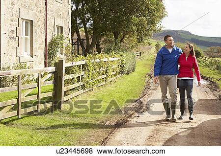 Couple on country walk View Large Photo Image Stock Photo - Couple on country walk. Fotosearch