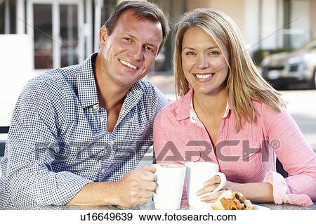 Couple sitting at sidewalk café View Large Photo Image Stock Photo - Couple sitting at sidewalk café. Fotosearch