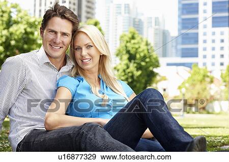 Couple sitting in city park View Large Photo Image Stock Photo - Couple sitting in city park. Fotosearch
