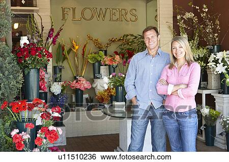 Couple standing outside florist View Large Photo Image Stock Photograph - Couple standing outside florist. Fotosearch