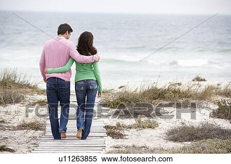 Couple walking by the sea View Large Photo Image Stock Photography - Couple walking by the sea. Fotosearch