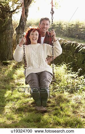 Couple with country garden swing View Large Photo Image Stock Image - Couple with country garden swing. Fotosearch