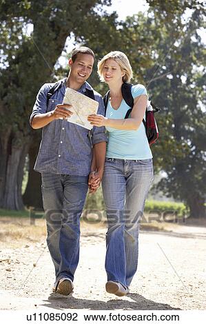 Couple with map on country walk View Large Photo Image Stock Image - Couple with map on country walk. Fotosearch
