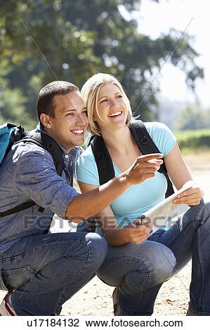 Stock Image - Couple with map on country walk. Fotosearch