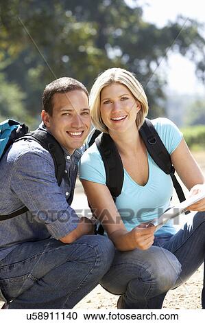 Couple with map on country walk View Large Photo Image Stock Image - Couple with map on country walk. Fotosearch