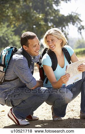 Stock Photo - Couple with map on country walk. Fotosearch