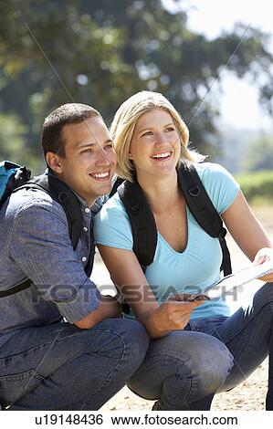 Couple with map on country walk View Large Photo Image Stock Photograph - Couple with map on country walk. Fotosearch