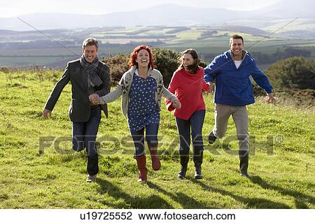 Stock Image - Couples on country walk. Fotosearch