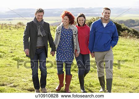 Couples on country walk View Large Photo Image Stock Photo - Couples on country walk. Fotosearch