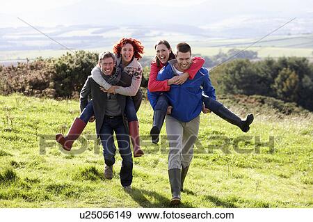 Couples on country walk View Large Photo Image Stock Photo - Couples on country walk. Fotosearch