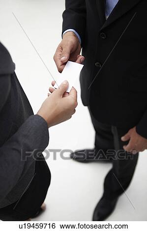 Stock Photograph - Detail businessman and woman exchanging cards. Fotosearch