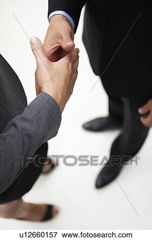 Stock Photo - Detail businessman and woman shaking hands. Fotosearch