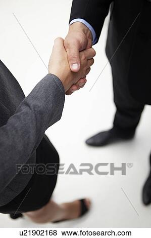 Stock Photo - Detail businessman and woman shaking hands. Fotosearch