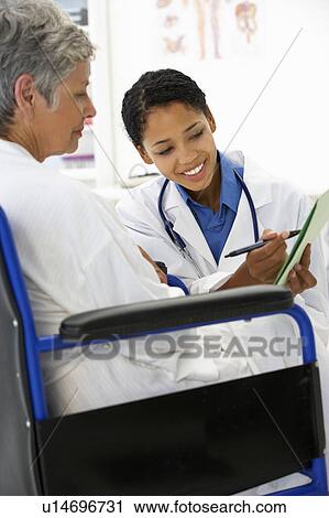 Doctor with female patient View Large Photo Image Stock Image - Doctor with female patient. Fotosearch