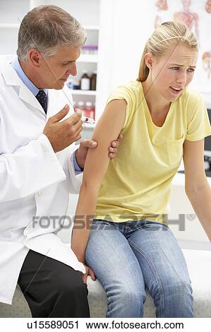 Stock Image - Doctor with female patient. Fotosearch