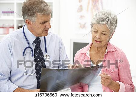 Stock Image - Doctor with female patient. Fotosearch