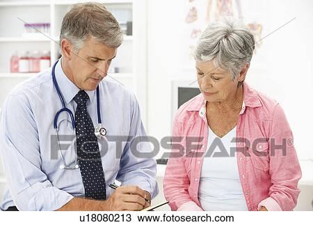 Stock Image - Doctor with female patient. Fotosearch