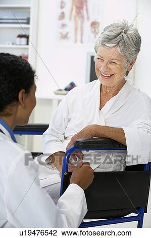 Doctor with female patient View Large Photo Image Stock Image - Doctor with female patient. Fotosearch