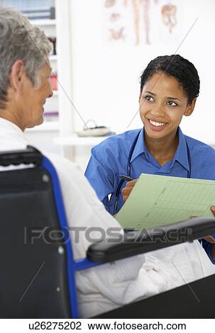 Doctor with female patient View Large Photo Image Stock Image - Doctor with female patient. Fotosearch