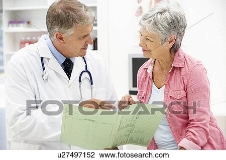 Doctor with female patient View Large Photo Image Stock Image - Doctor with female patient. Fotosearch