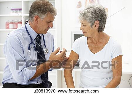 Stock Image - Doctor with female patient. Fotosearch